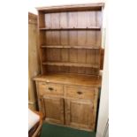 Late 19th/ early 20th century stripped pine dresser, the plate rack with three shelves and hanging