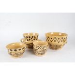 20th Century pottery slipware, to include a porringer, another and two cups, (4)