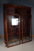 Edwardian mahogany ebony and boxwood strung bookcase, the two astragal glazed doors opening to