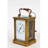 Early 20th Century brass cased carriage clock, the white dial with Roman numerals and outer