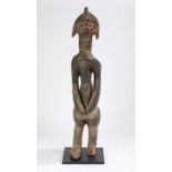 Sierra Leone Mende standing figure, the head with carved linear decorations, above a ringed neck,