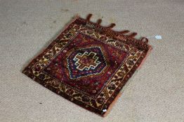 Qashqai small rug, the central panel with a multi coloured medallion, within a cream border with