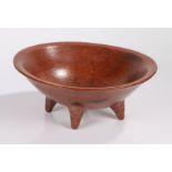 African red ware bowl, possibly Egyptian, the dished bowl raised on four tapering feet, 33.5cm