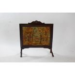 20th century walnut and needlework firescreen, depicting a forest scene with deer, 74cm wide