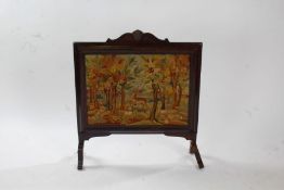 20th century walnut and needlework firescreen, depicting a forest scene with deer, 74cm wide