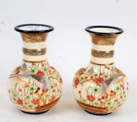 Pair of Japanese satsuma ware crackle glazed vases, with raised bird and foliate decoration, 19cm