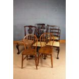 Pair of Chippendale style mahogany dining chairs, with fret carved slats, raised on claw on ball