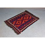 Afghan prayer rug, the red ground with blue and orange motifs, 76cm x 110cm