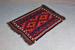 Afghan prayer rug, the red ground with blue and orange motifs, 76cm x 110cm