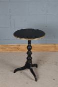 Neoclassical style occasional table, the ebonised and gilt circular top raised on a turned stem