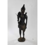 Large carved wooden African floor standing figure, in the form of a hunter, with an animal draped
