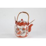 Japanese Kutani teapot, 20th century, having cane handle, painted in iron red and gilt with