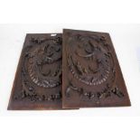 Pair of 20th century carved oak panels, each carved with mythical beast heads, 33cm wide x 55cm high