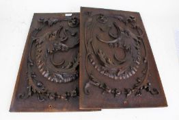 Pair of 20th century carved oak panels, each carved with mythical beast heads, 33cm wide x 55cm high
