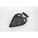 Cast iron masonic trivet, with depictions of interlocked hands, birds, sun, moon and initials RB,