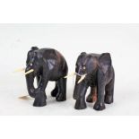 Two carved and ebonized elephants, with bone tusks, each approx. 15cm tall (2)