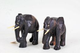 Two carved and ebonized elephants, with bone tusks, each approx. 15cm tall (2)