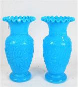 Pair of late Victorian blue pressed glass vases, having frilled rims above a baluster body with