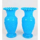 Pair of late Victorian blue pressed glass vases, having frilled rims above a baluster body with