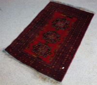 Persian rug, the red ground with three Heriz medallions, within multiple geometric borders, 123cm