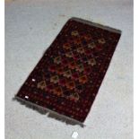 Middle Eastern prayer rug, the red ground with bands of geometric motifs, 100cm x 52cm
