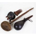 African carved wooden spoon, 50cm long, a pair of ebonised carved body ornaments, a wooden comb, and