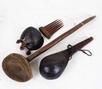 African carved wooden spoon, 50cm long, a pair of ebonised carved body ornaments, a wooden comb, and