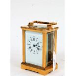 Early 20th Century brass cased carriage clock, the white dial with Roman numerals and Arabic outer