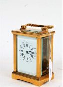 Early 20th Century brass cased carriage clock, the white dial with Roman numerals and Arabic outer