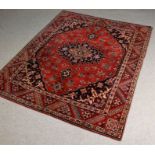 Persian Qashqai type rug, the red and blue ground with a central medallion and floral decoration,