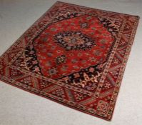 Persian Qashqai type rug, the red and blue ground with a central medallion and floral decoration,