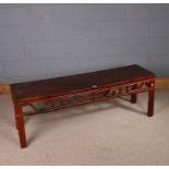 Chinese painted softwood table, of low rectangular form, the top above a carved pierced frieze and
