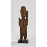 Dogon standing female figure, the head with carved facial features, above a long neck flanked by