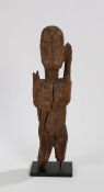 Dogon standing female figure, the head with carved facial features, above a long neck flanked by