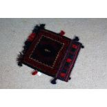 Persian salt bag, the blue field with motifs, within a red geometric border, flanked by tassels,