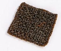 Unusual item, chainmail metal cleaner, a square of chainmail attached to a leather pad, used by