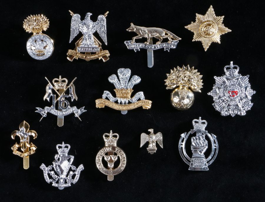 Selection of British army cap badges in anodised aluminium to include, The Border Regiment, slider