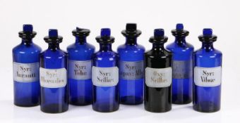 Eight blue glass apothecary bottles, the white labels to include "Oxy: Scillae", "Syr: Auranti", "