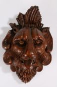 19th Century carved bust if a lion, with a curled mane and protruding tongue, 29cm long