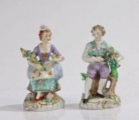 Pair of Sitzendorf porcelain figures, of a gentleman reclining on a stump cutting some roses, the