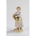 Meissen porcelain figure, of a young lady with flowers in her folded hat, her bare feet on a gilt
