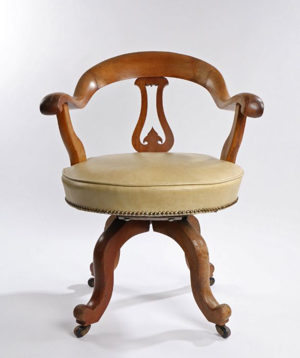 Victorian mahogany desk chair, the arched back above a shaped splat and stuff over swivel seat above