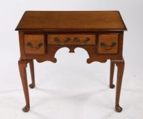 George III oak lowboy, the rectangular top above three drawers and a shaped apron raised upon hipped
