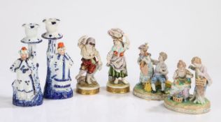 Porcelain figures, to include a pair of figural groups modelled as young couples, 12.5cm high, the