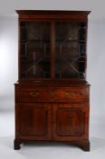 Victorian mahogany and boxwood strung secretaire bookcase, the concave cornice above the glazed