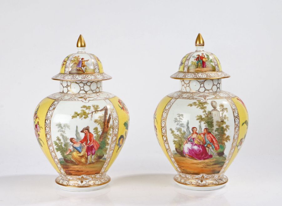 Pair of porcelain lidded vases, the gilt pointed lids with polychrome figures and flower sprigs in
