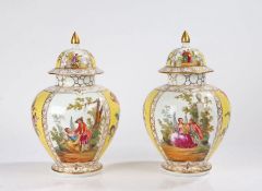 Pair of porcelain lidded vases, the gilt pointed lids with polychrome figures and flower sprigs in