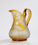 19th Century Bohemian amber glass jug, engraved with a stag and doe walking among a grass and tree