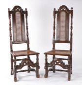 Pair of late 17th Century oak caned chairs, the tall arched rail flanked by finials above the cane