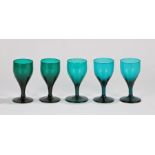 Matched set of five 19th Century English green glass wine glasses, with a tapering bowl above a stem